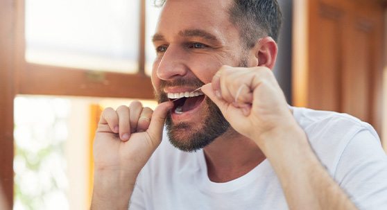 Man flossing his teeth