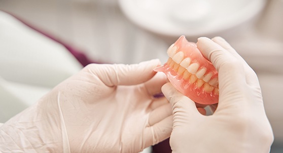 Dentist Lakewood holding implant dentures
