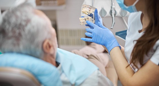 Dental team member speaking to patient during consultation