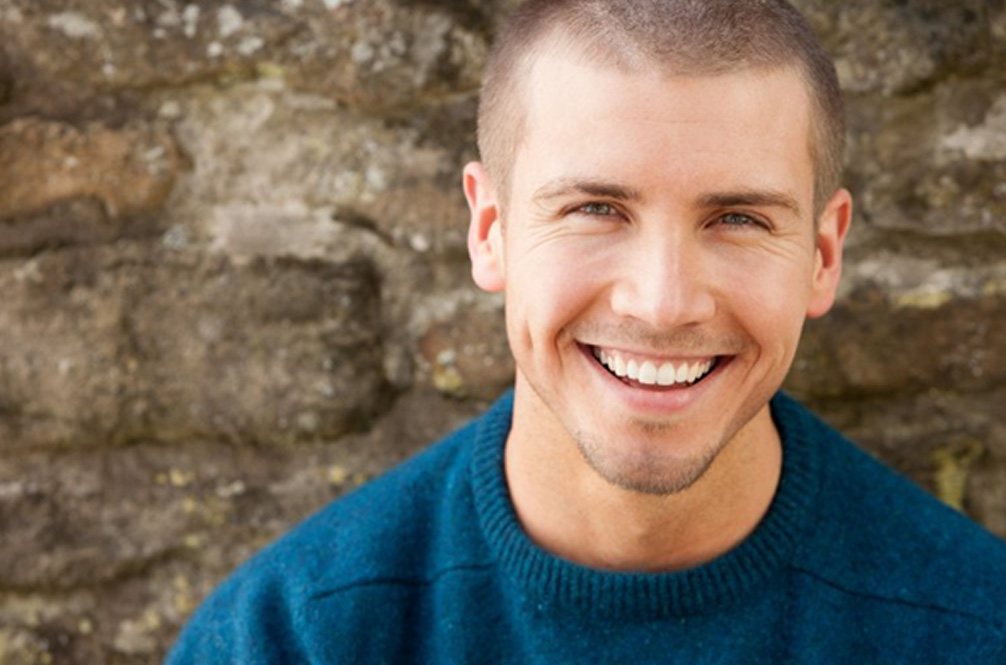 a man smiling with bright and healthy teeth