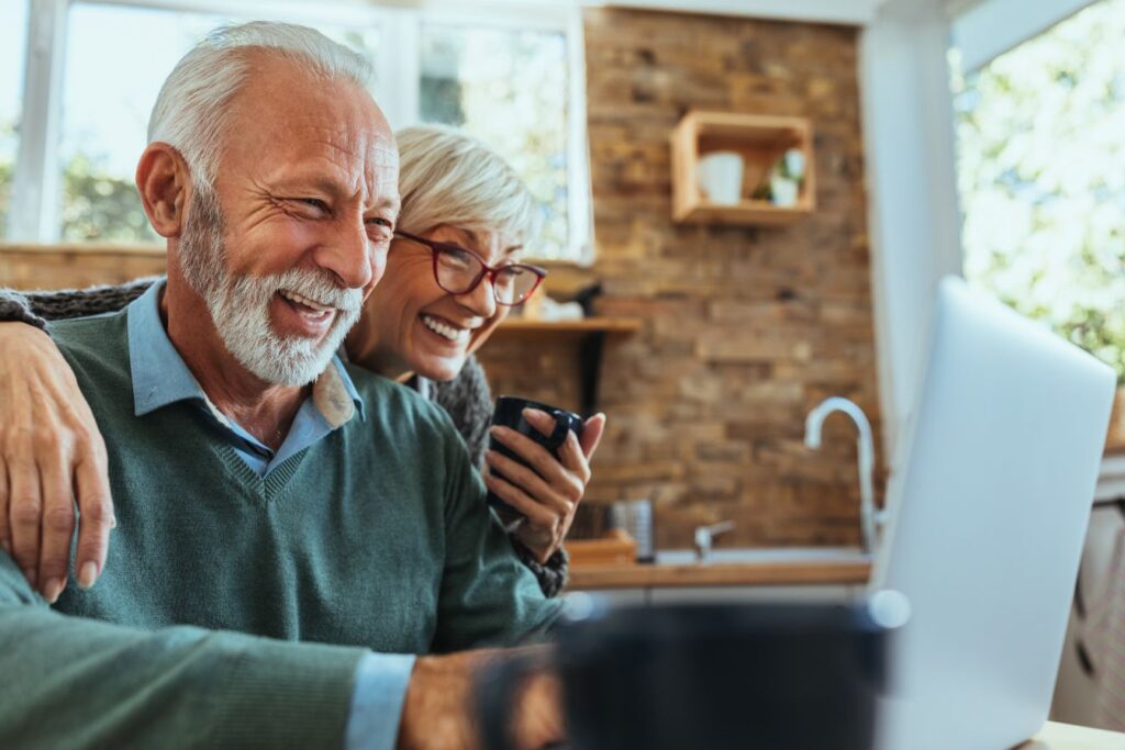A senior couple looking at the computer together.